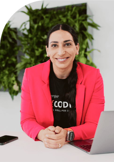 woman smiling at desk with laptop