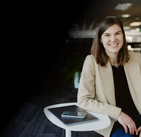 Professional woman with closed laptop smiling