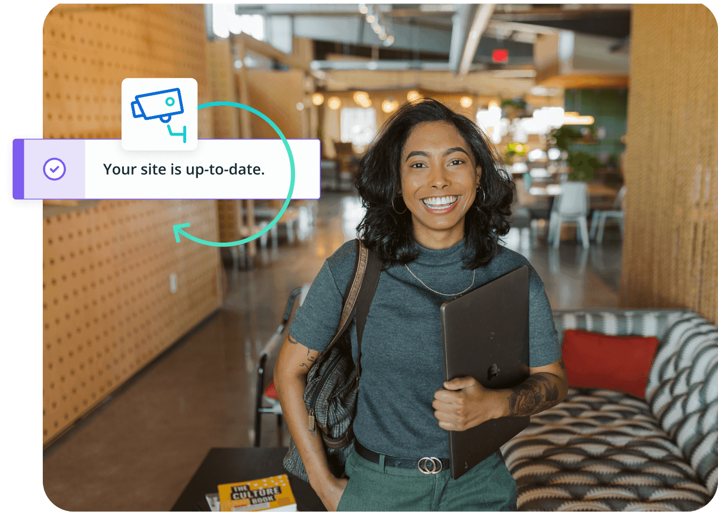 woman holding laptop in office setting